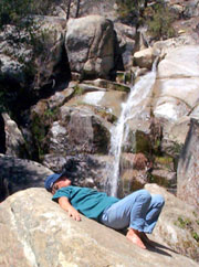 a retreatant rests at a nearby waterfall